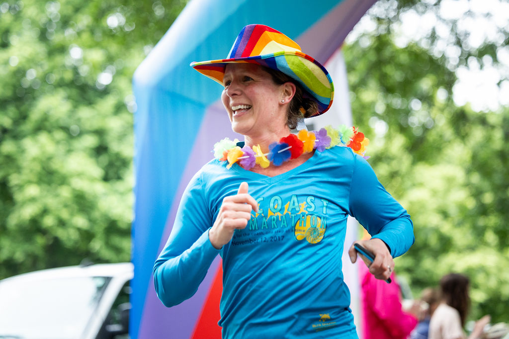 Photo of a runner wearing a colorful hat and a blue shirt